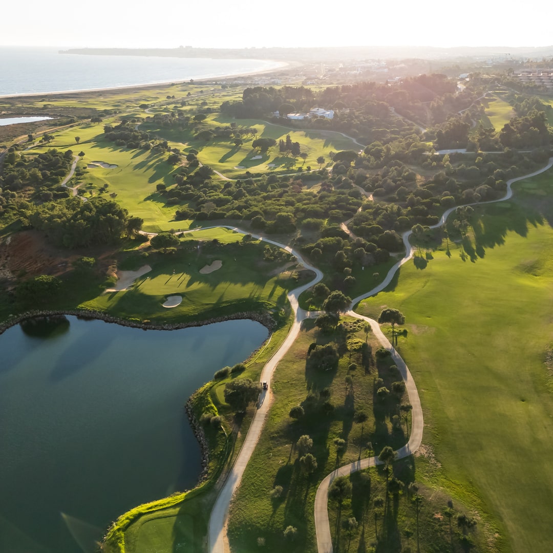 Aerial view of lakeside green and parkland fairways at Palmares Golf, near Lagos, Algarve